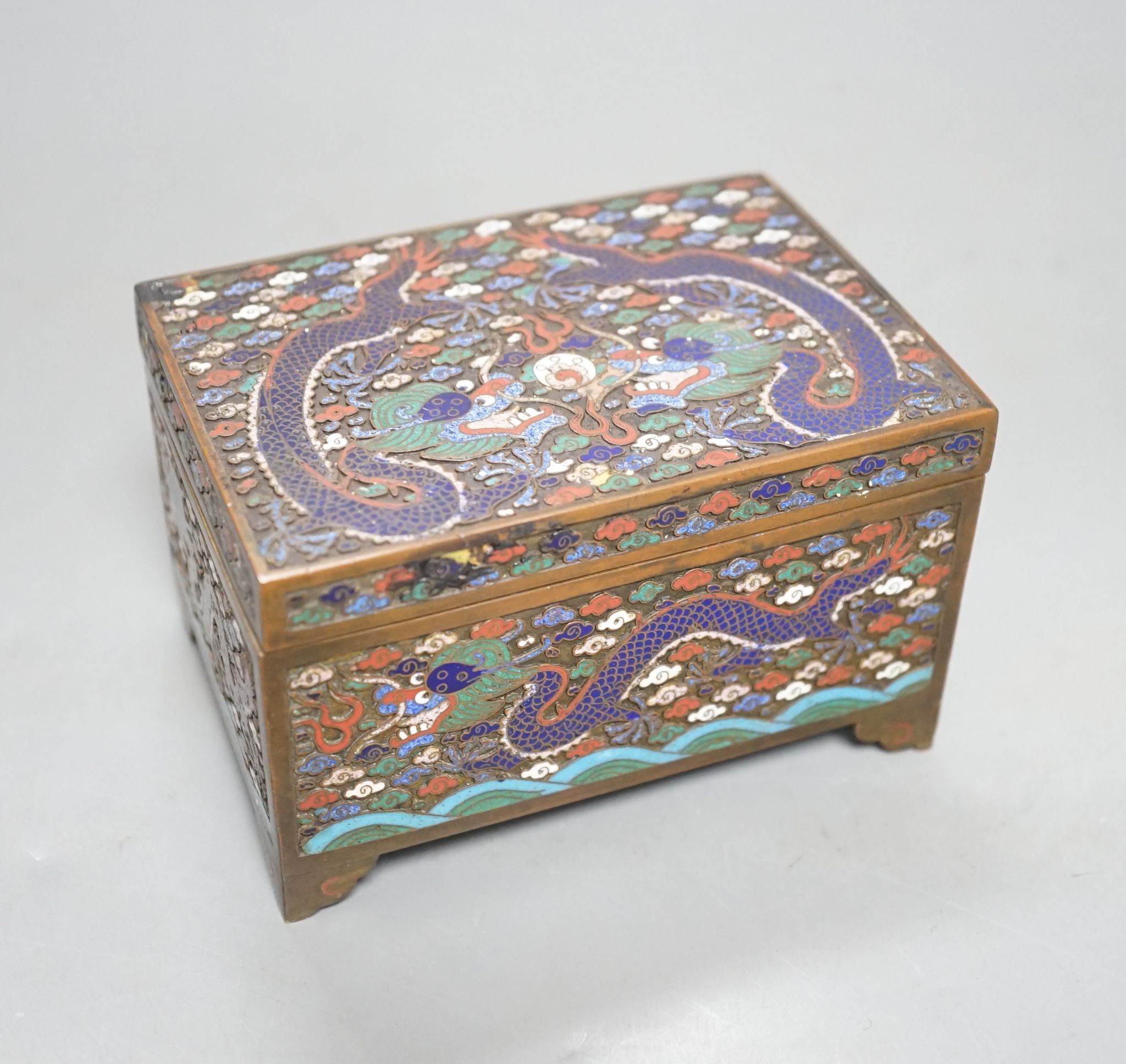 A Chinese bronze and cloisonné enamel ‘dragon’ box and cover, early 20th century, 6 cms high x 11.5 cms wide.